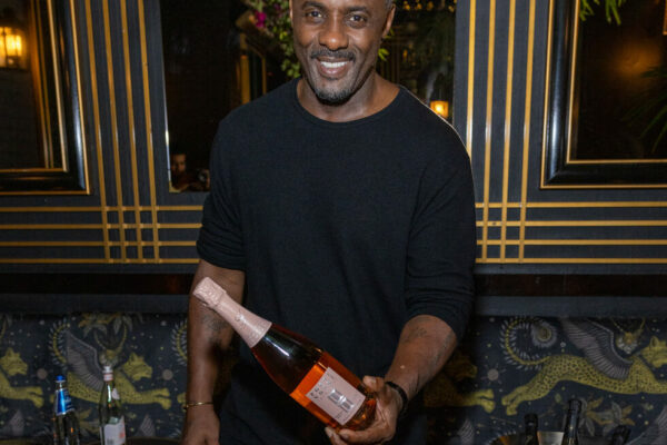 Idris Elba with a bottle of his newly launched Petite Porte Noir Rosé Champagne